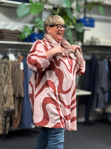 Anderledes tunika til plus size kvinden. Den er med stolpelukning, lange ærmer og en klassisk skjortekrave. 