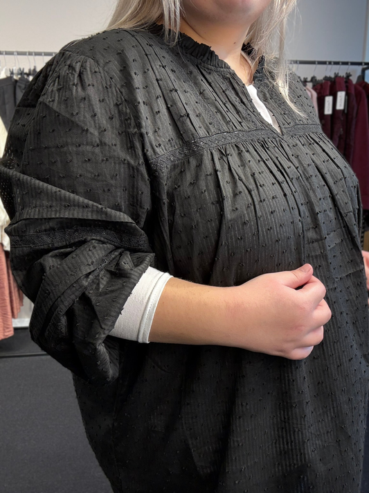 Smart plus size bluse med søde blonde detaljer - den er med v-hals og lange ærmer, hvor der er elastik ved ærmets afslutning. Dette er en pyntet sag som kan bruges både til hverdag og fest.