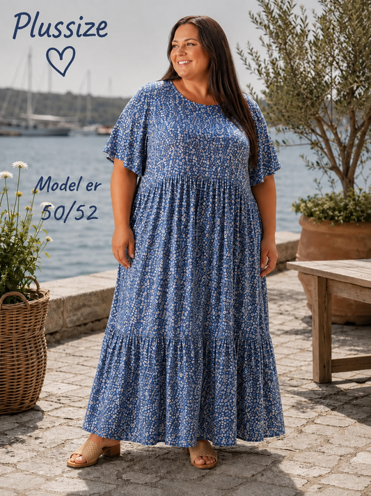 Denne smukke kjole er samme gode facon som vores Lolli kjole. Denne model er bare med blomster-print i stedet. 

Billedet er AI-genereret for at vise kjolen på et menneske.
