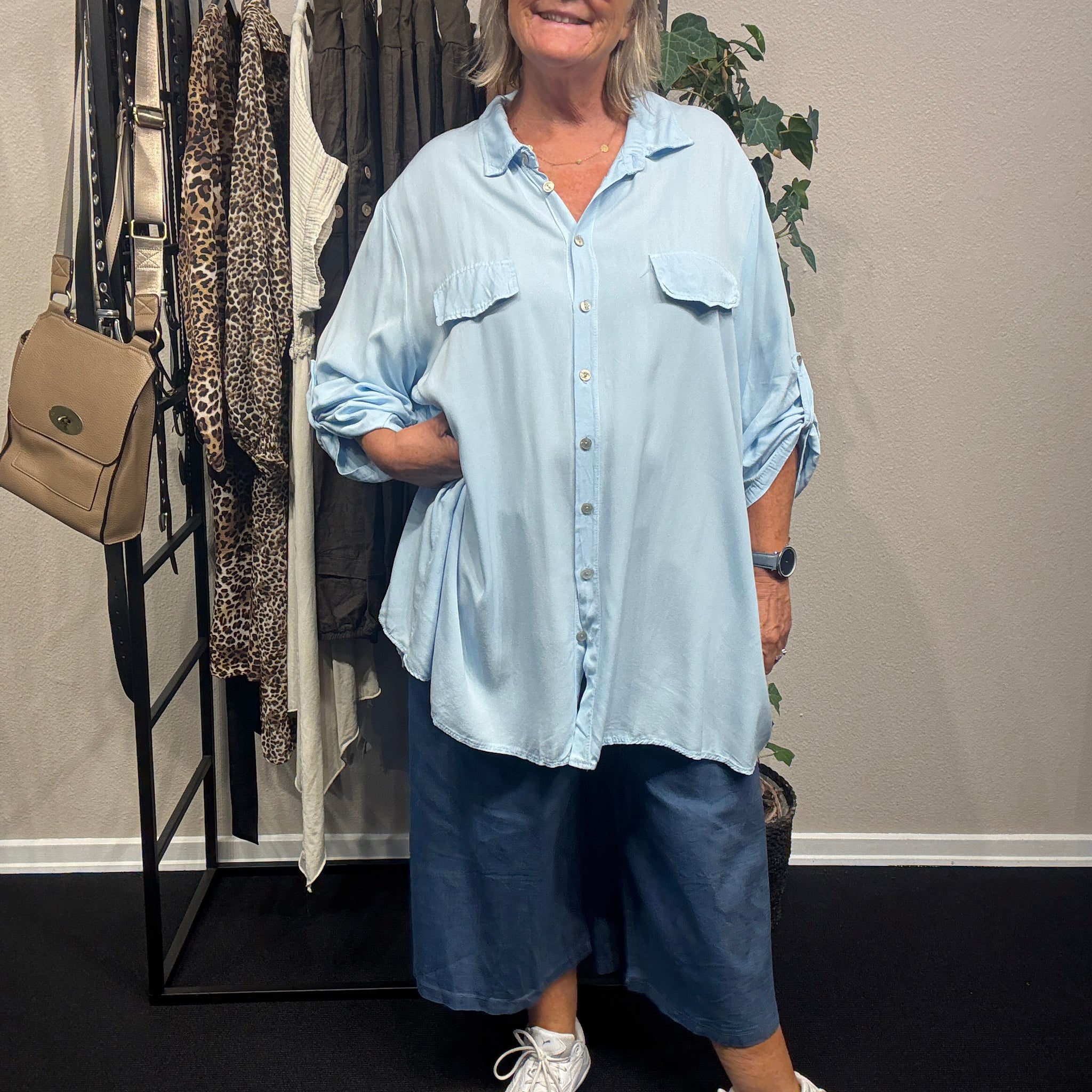 Inge er plus size skjorten, som kan passes af de fleste. Den er dejlig lang, da den har en længde på hele 84cm. Brug den som en åben jakke eller helt lukket, den er nemlig gennemknappet. 