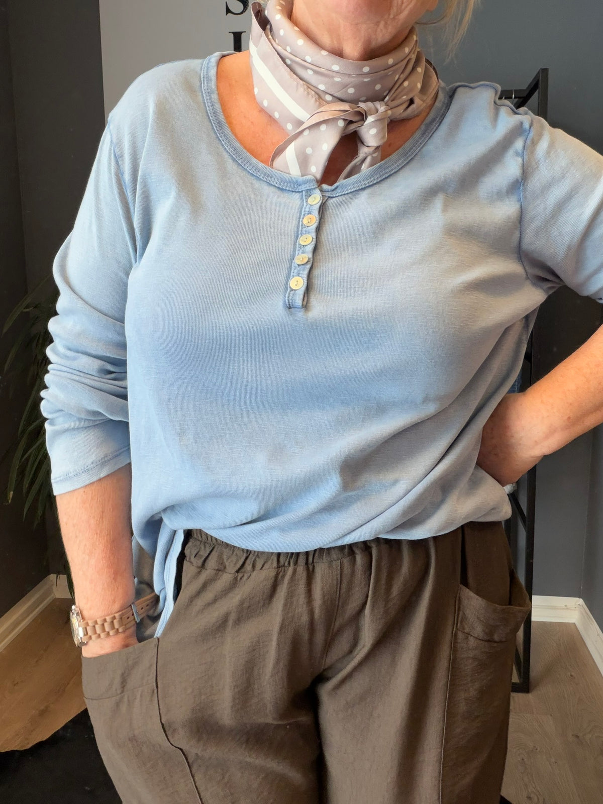Plus size t-shirt med langt ærme, rund hals med stolpe ned i knaplukning, vask er stone wash hvilket betyder at farver er uens. Den er i en lækker bomuldskvalitet, som er åndbar og god at have under noget andet.