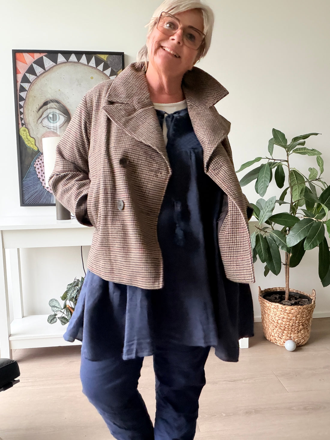 Pepitaternet jakke fra Only Carmakoma. Den er perfekt til den modebevidste plus size kvinde. Den er med kommer og flot knaplukning foran. Carmoreno ternet kort plussize jakke. Billedet er Ai generet.