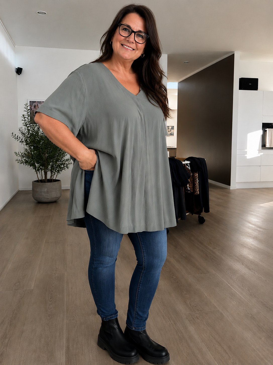 Pernille viskose T-shirt i A-shape med løs og luftig pasform, vist på model der er 168 cm høj og bruger størrelse 46/48. T-shirten er i en mørkebrun nuance og har korte, brede ærmer samt en flatterende V-hals, der giver et afslappet og feminint look. Den falder flot over kroppen og giver god bevægelsesfrihed, hvilket gør den ideel til både hverdag og komfortabel styling.

Billedet er genereret vha. AI-teknologi for at vise t-shirten på en person.