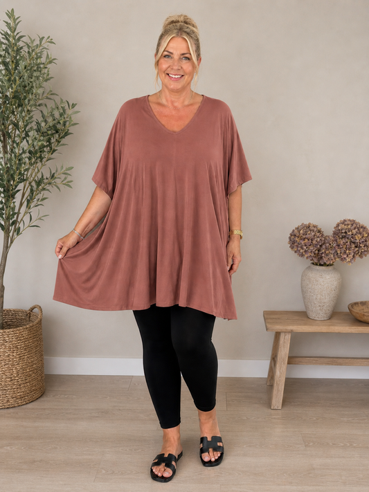 Pernille viskose T-shirt i A-shape med løs og luftig pasform, vist på model der er 168 cm høj og bruger størrelse 46/48. T-shirten er i en mørkebrun nuance og har korte, brede ærmer samt en flatterende V-hals, der giver et afslappet og feminint look. Den falder flot over kroppen og giver god bevægelsesfrihed, hvilket gør den ideel til både hverdag og komfortabel styling.