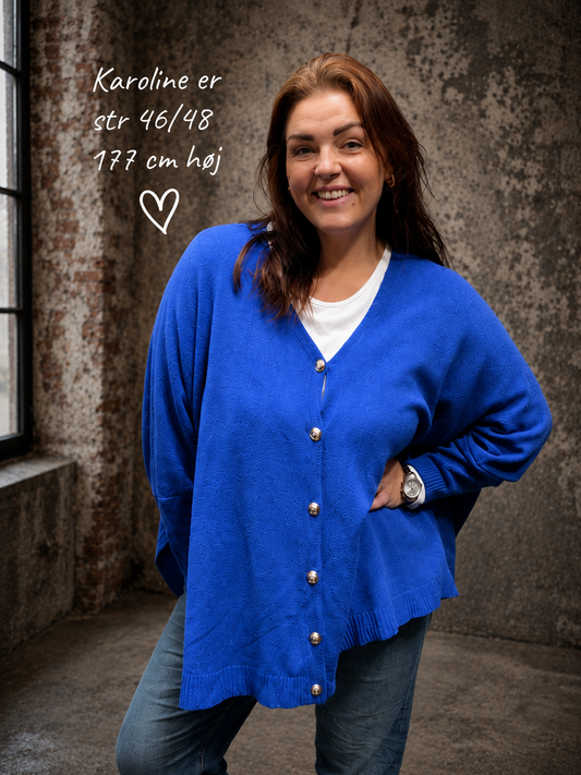 Gerda strik cardigan er en skøn basiscardigan, der passer til det meste i garderoben. Den har en løs, oversized pasform, fine knapper foran og en blød strikkvalitet, som gør den behagelig at have på hele dagen.