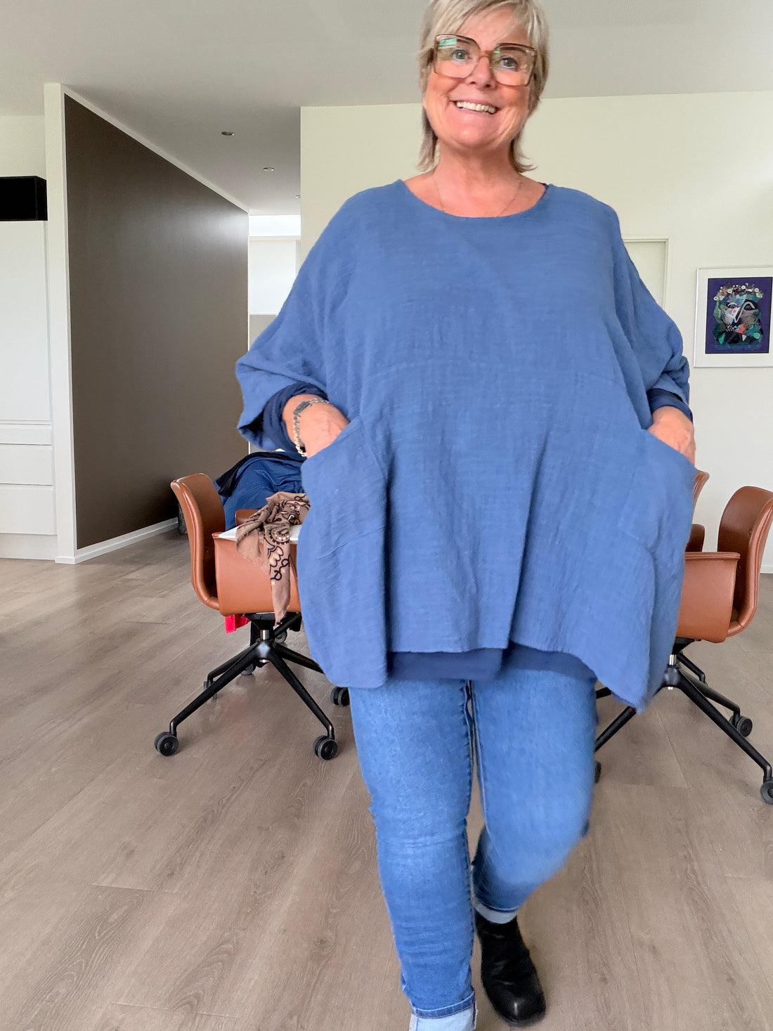 **Alt-tekst – Susanne plussize bomuldstunika (AI-genereret billede):**

AI-genereret billede af en smilende plus-size model iført Susanne bomuldstunika i mørk brun. Tunikaen har en løs, oversize pasform med rund hals, korte brede ærmer og store påsyede lommer foran. Den er stylet med rustfarvede bukser og komfortable sko i et råt industrielt miljø, som fremhæver tunikaens afslappede og moderne udtryk. Ideel til kvinder, der ønsker komfort, bevægelsesfrihed og et stilfuldt hverdagslook.