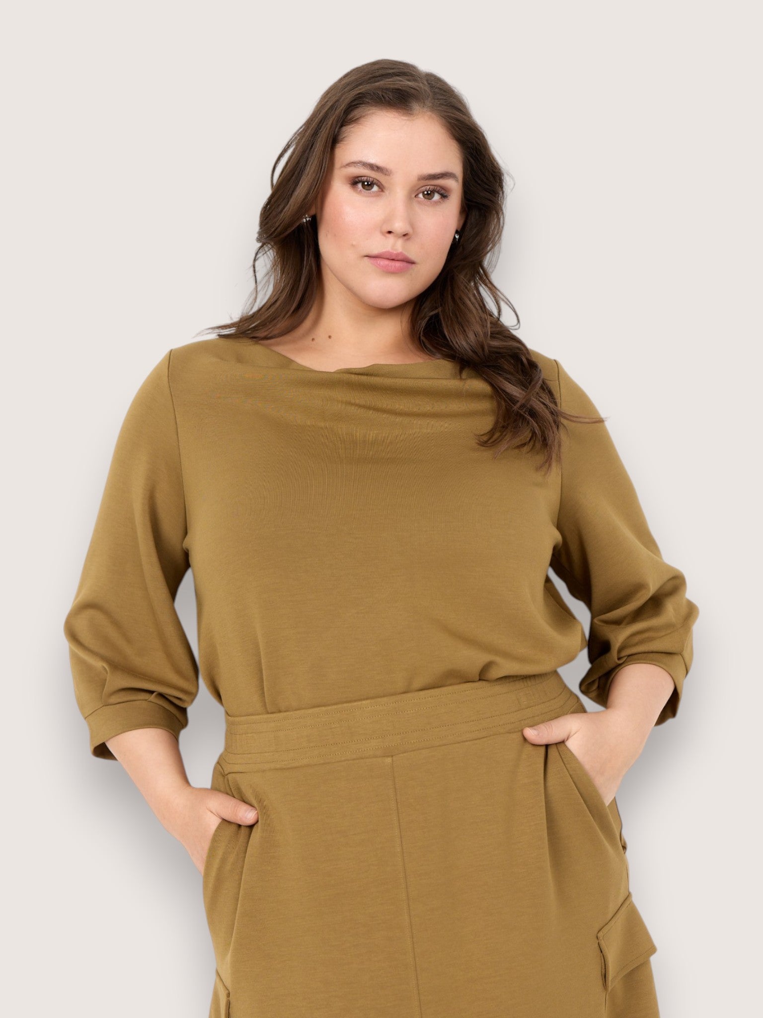 “Komfortabel plus size top fra Wasabi Concept i blød viskose. SABINA 93 har en løs pasform, flot anderledes hals og et enkelt design, der gør den perfekt til både hverdag og lag-på-lag styling.”